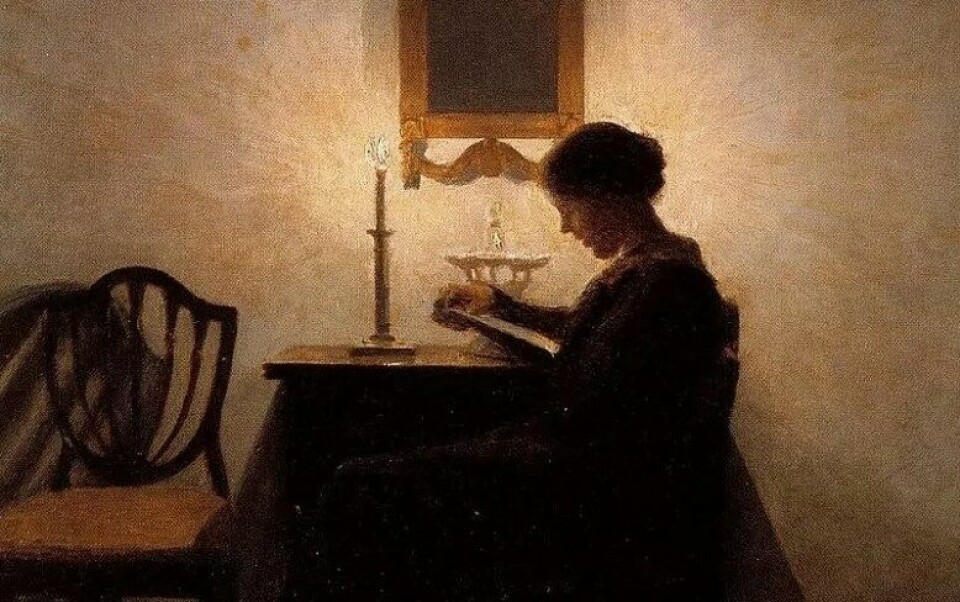 Woman reading by candlelight av Peter Vilhelm Ilsted (1861–1933). (Kilde: Flickr/Plum leaves)
